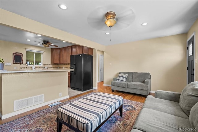 2069 E 116th Ave, Northglenn, CO 80233 - living area with a ceiling fan, recessed lighting, and light wood-type flooring