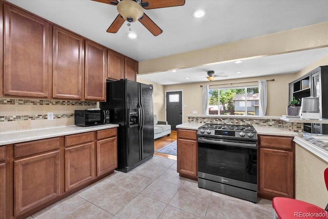 2069 E 116th Ave, Northglenn, CO 80233 - kitchen featuring stainless steel electric range oven, black refrigerator with ice dispenser, a ceiling fan, tasteful backsplash, and light countertops