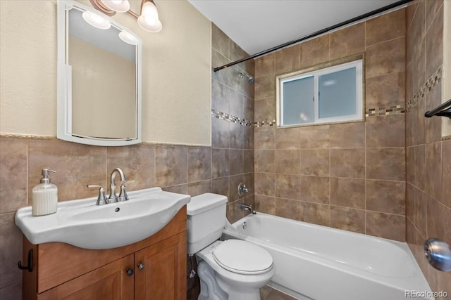 2069 E 116th Ave, Northglenn, CO 80233 - full bath featuring vanity, tile walls, and shower / washtub combination