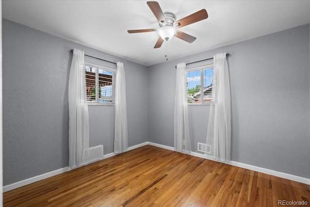 2069 E 116th Ave, Northglenn, CO 80233 - spare room featuring healthy amount of natural light, light wood finished floors, and a ceiling fan