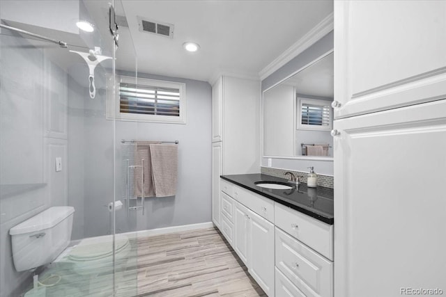 2069 E 116th Ave, Northglenn, CO 80233 - full bath with vanity, a shower stall, wood finished floors, ornamental molding, and recessed lighting