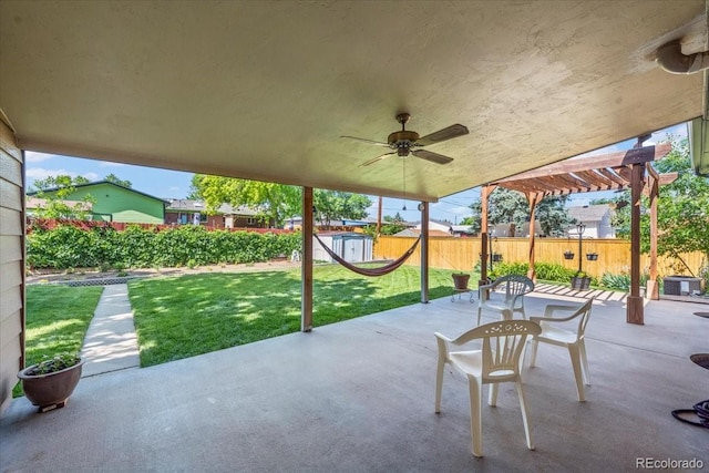 2069 E 116th Ave, Northglenn, CO 80233 - fenced backyard featuring a patio area, a pergola, a ceiling fan, and an outdoor structure