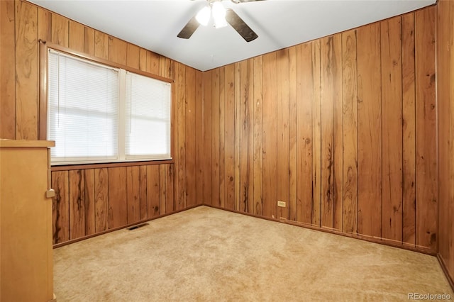 2732 W Archer Pl, Denver, CO 80219 - empty room with ceiling fan, wood walls, and carpet