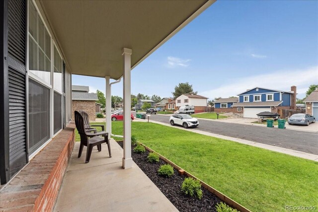 11021 Otis St, Westminster, CO 80020 - porch featuring a residential view and a lawn