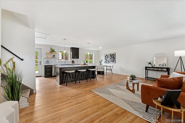 11021 Otis St, Westminster, CO 80020 - living area featuring light wood-type flooring and baseboards