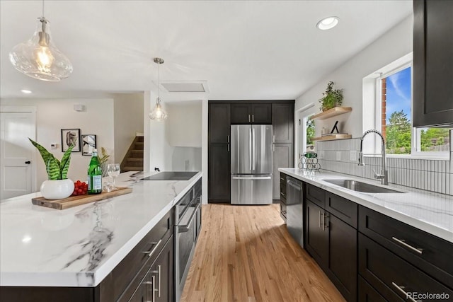 11021 Otis St, Westminster, CO 80020 - kitchen featuring freestanding refrigerator, a sink, dishwasher, open shelves, and light wood-style floors