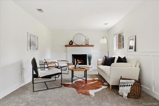 11021 Otis St, Westminster, CO 80020 - living room with a brick fireplace, carpet, a wainscoted wall, and a decorative wall