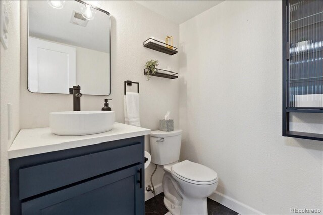 11021 Otis St, Westminster, CO 80020 - bathroom with baseboards, vanity, and toilet