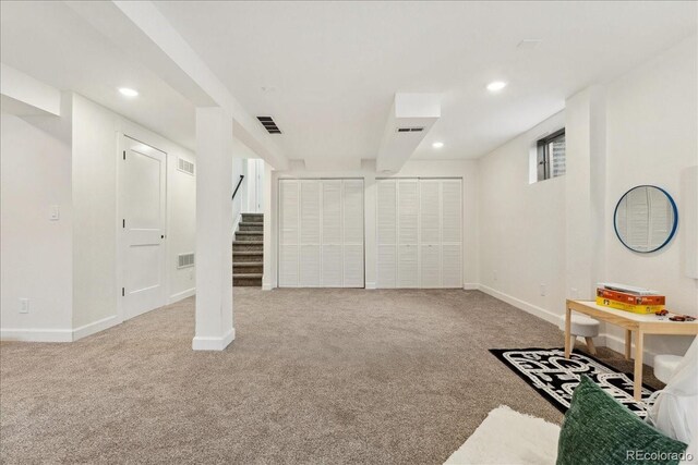 11021 Otis St, Westminster, CO 80020 - finished below grade area with carpet flooring, stairway, baseboards, and recessed lighting