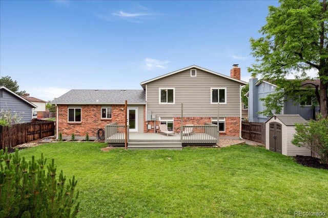 11021 Otis St, Westminster, CO 80020 - back of house featuring brick siding, a wooden deck, a chimney, and a shingled roof