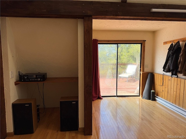 274 Lincoln Dr, Idaho Springs, CO 80452 - unfurnished room featuring wood-type flooring, baseboard heating, wainscoting, and a textured wall