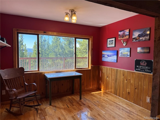274 Lincoln Dr, Idaho Springs, CO 80452 - living area with wood finished floors, wainscoting, wood walls, and a chandelier