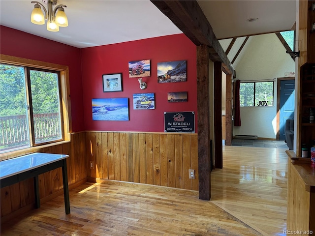 274 Lincoln Dr, Idaho Springs, CO 80452 - dining space featuring wood finished floors, a chandelier, a wainscoted wall, baseboard heating, and wood walls