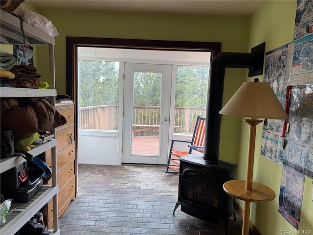 274 Lincoln Dr, Idaho Springs, CO 80452 - doorway with plenty of natural light, a wood stove, and brick patterned floors