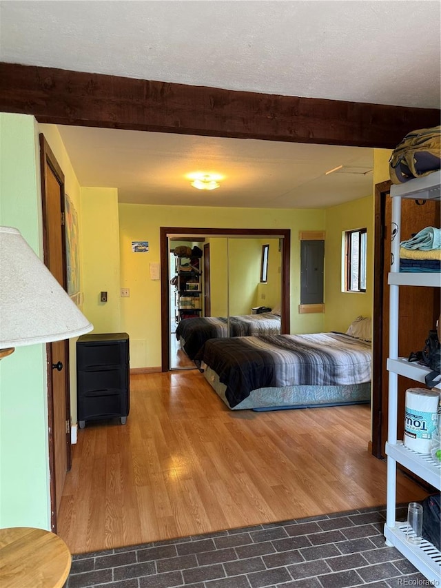274 Lincoln Dr, Idaho Springs, CO 80452 - living area featuring beamed ceiling, electric panel, and dark wood-style flooring