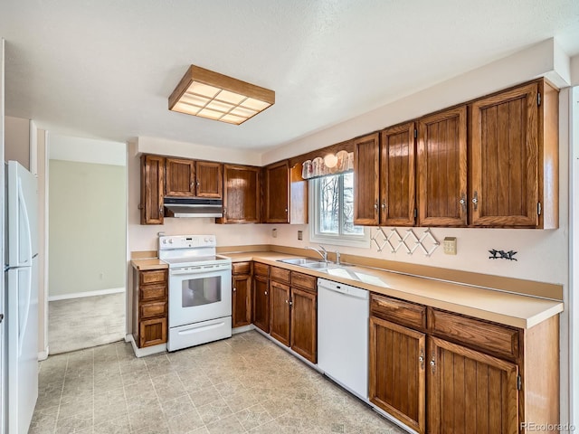 kitchen featuring white appliances and sink