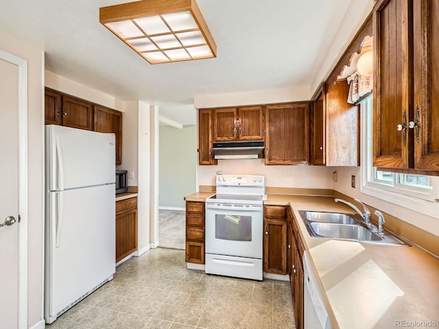 kitchen featuring white appliances and sink