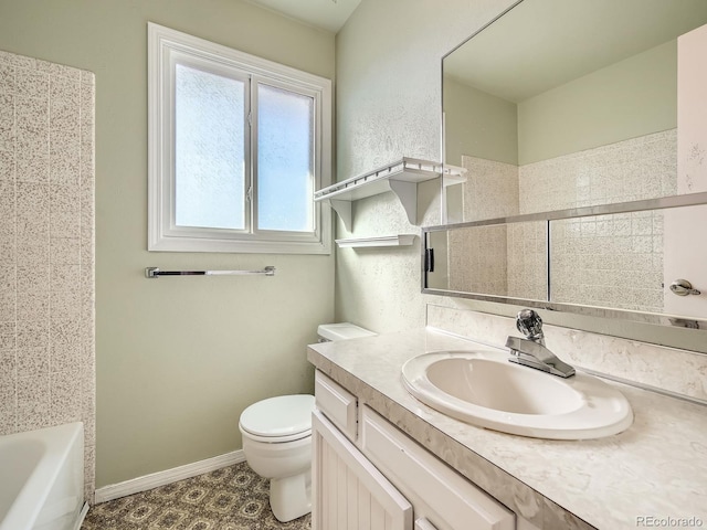 full bathroom featuring tiled shower / bath, vanity, and toilet