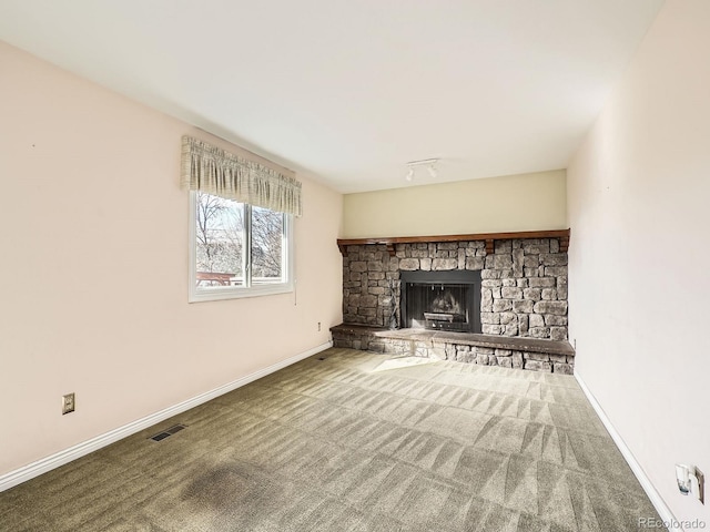 unfurnished living room featuring a fireplace and carpet