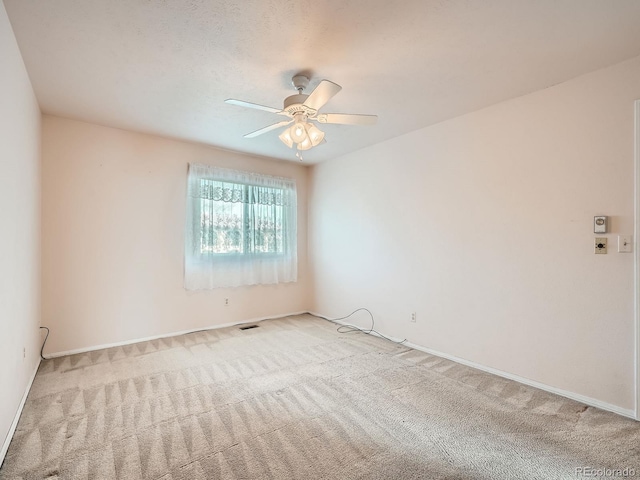 unfurnished room featuring ceiling fan and light colored carpet