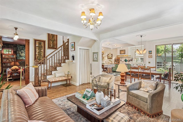 2324 S Columbine St, Denver, CO 80210 - living room featuring wood finished floors, a chandelier, stairway, and baseboards