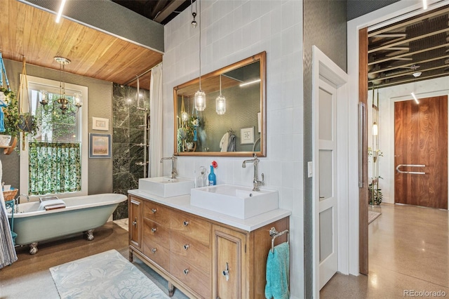 2324 S Columbine St, Denver, CO 80210 - bathroom featuring double vanity, a freestanding bath, and tile walls