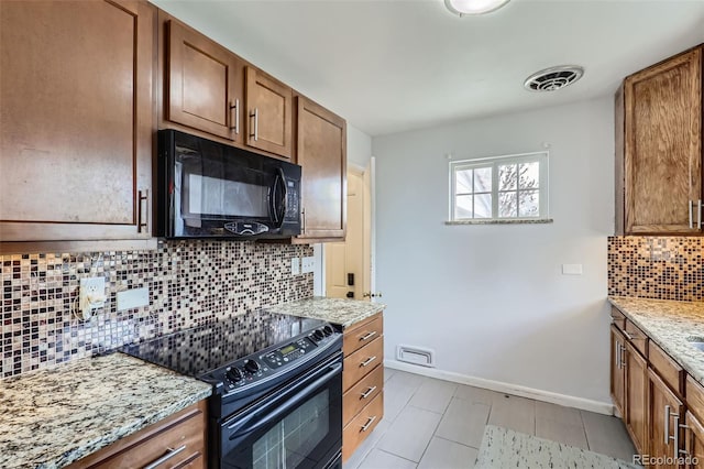 3600 Olive St, Denver, CO 80207 - kitchen with decorative backsplash, baseboards, brown cabinets, light stone counters, and black appliances