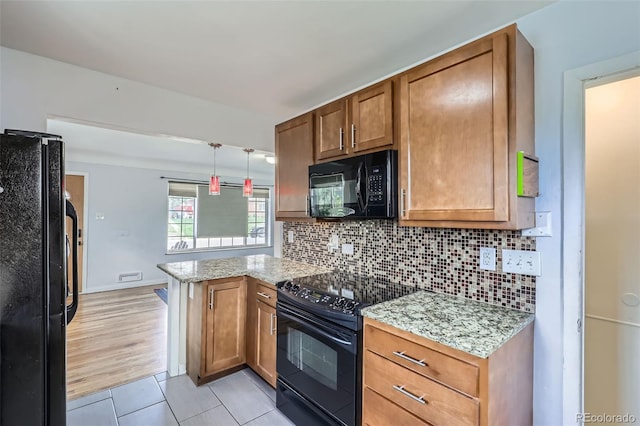 3600 Olive St, Denver, CO 80207 - kitchen with decorative backsplash, a peninsula, brown cabinets, light tile patterned floors, and black appliances