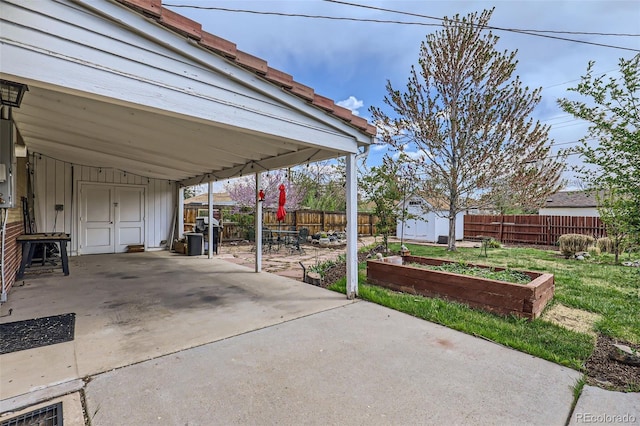 3600 Olive St, Denver, CO 80207 - view of patio / terrace featuring an outbuilding, a shed, and a fenced backyard