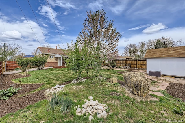 3600 Olive St, Denver, CO 80207 - view of yard featuring an outdoor structure, a storage shed, and a fenced backyard