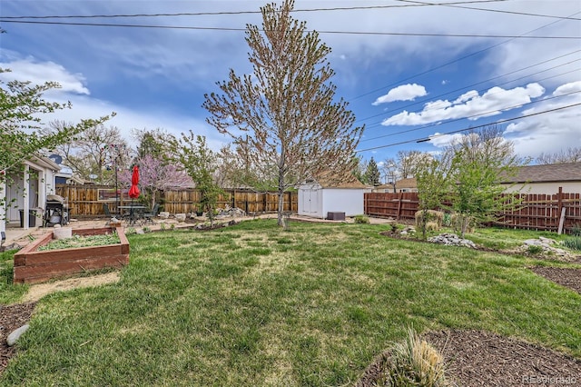 3600 Olive St, Denver, CO 80207 - view of yard with an outbuilding, a garden, a shed, and a fenced backyard