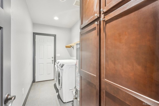 laundry room featuring visible vents, washer and dryer, baseboards, light floors, and laundry area