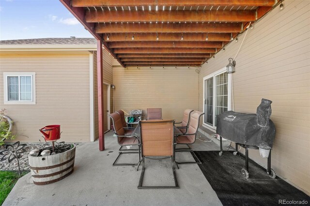 view of patio with a grill and outdoor dining area