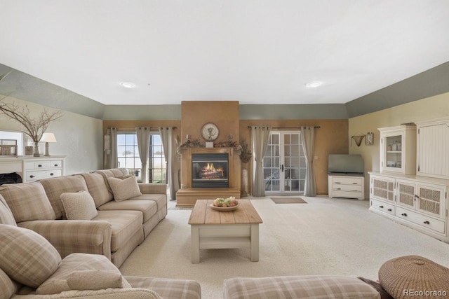 living room with a fireplace and light colored carpet