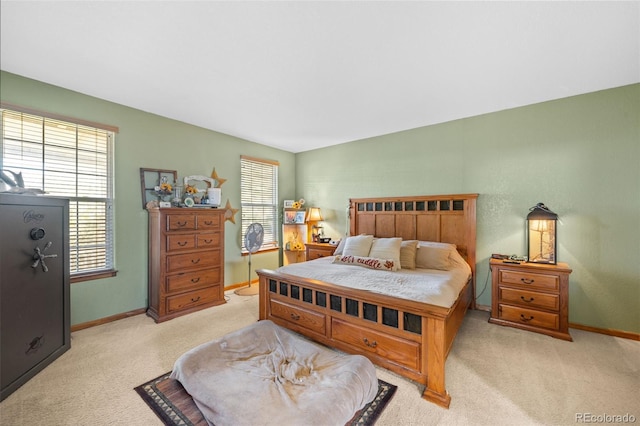 bedroom featuring baseboards and light colored carpet