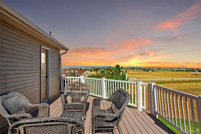 deck at dusk with a rural view