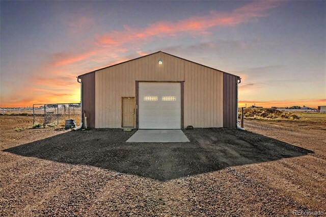 view of garage at dusk