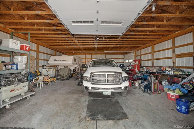 garage with metal wall and visible vents