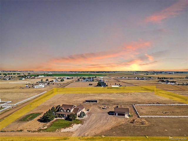 aerial view at dusk featuring a rural view