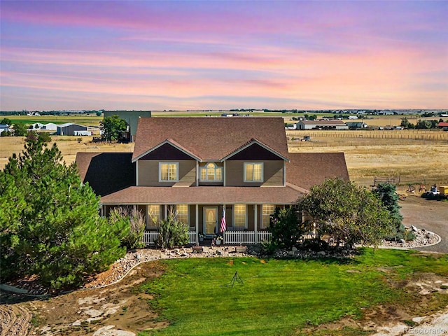 view of front of property with covered porch and a front lawn