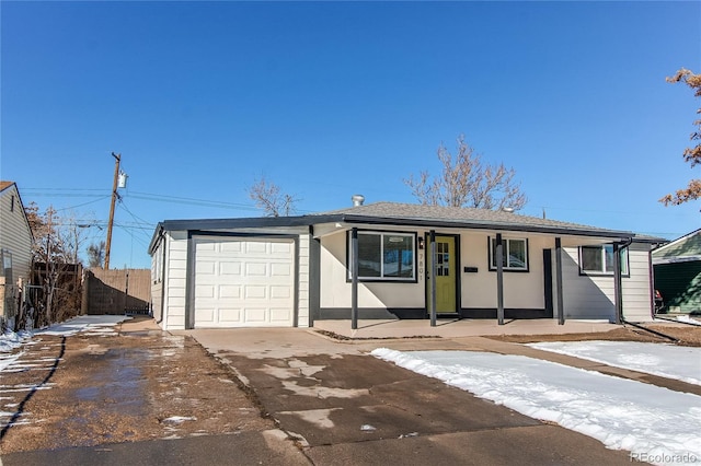 ranch-style home with covered porch and a garage