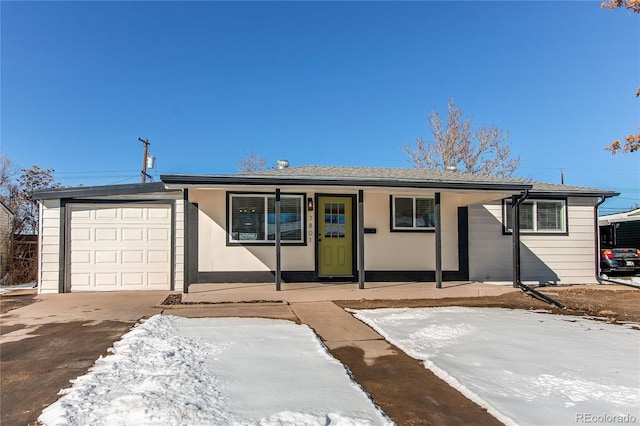 ranch-style house featuring covered porch and a garage