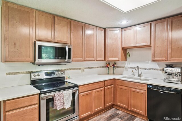 1213 S Taft Hill Rd, Fort Collins, CO 80521 - kitchen with stainless steel appliances, light countertops, wood finished floors, and recessed lighting