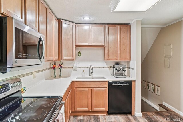 1213 S Taft Hill Rd, Fort Collins, CO 80521 - kitchen featuring stainless steel appliances, light wood finished floors, backsplash, crown molding, and light countertops