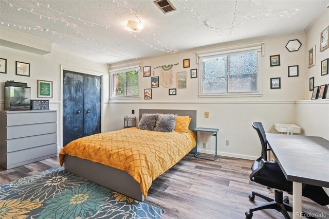 1213 S Taft Hill Rd, Fort Collins, CO 80521 - bedroom with wood finished floors, a textured ceiling, and a closet