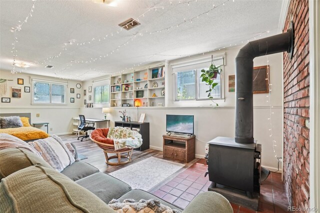 1213 S Taft Hill Rd, Fort Collins, CO 80521 - tiled living room featuring a textured ceiling and a wood stove