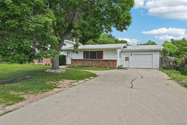 1213 S Taft Hill Rd, Fort Collins, CO 80521 - view of front of property with a garage, concrete driveway, a front yard, and brick siding