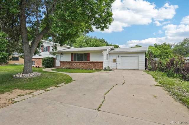 1213 S Taft Hill Rd, Fort Collins, CO 80521 - split level home featuring driveway, an attached garage, brick siding, and a front lawn
