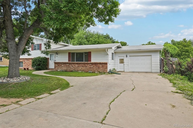 1213 S Taft Hill Rd, Fort Collins, CO 80521 - tri-level home with an attached garage, driveway, brick siding, and a front yard