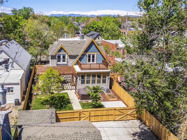 4348 Umatilla St, Denver, CO 80211 - back of house with french doors, a balcony, a fenced backyard, a mountain view, and a chimney